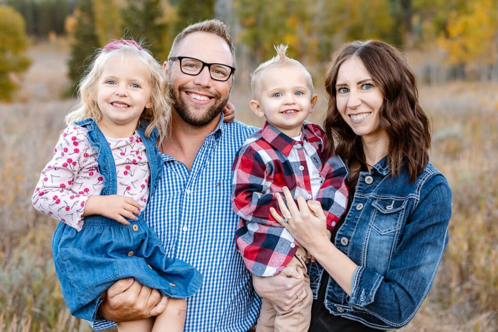 A beautiful family enjoys their family photo session with photographer Poppy & Hive Photography in the fall colors near Park City Utah