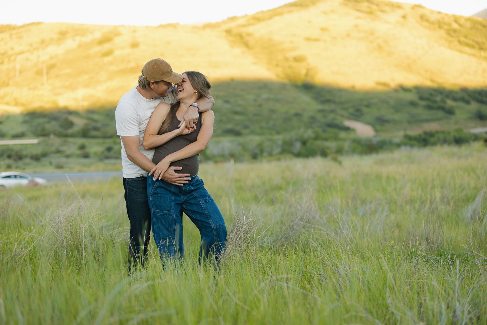 Lauren and Ben celebrate their new baby with a maternity photo session in a wildflower field near Salt Lake City with Poppy & Hive Photography